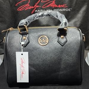 Marilyn Monroe Medium Style Pursr. Black in color. Red lining. Shoulder Strap.